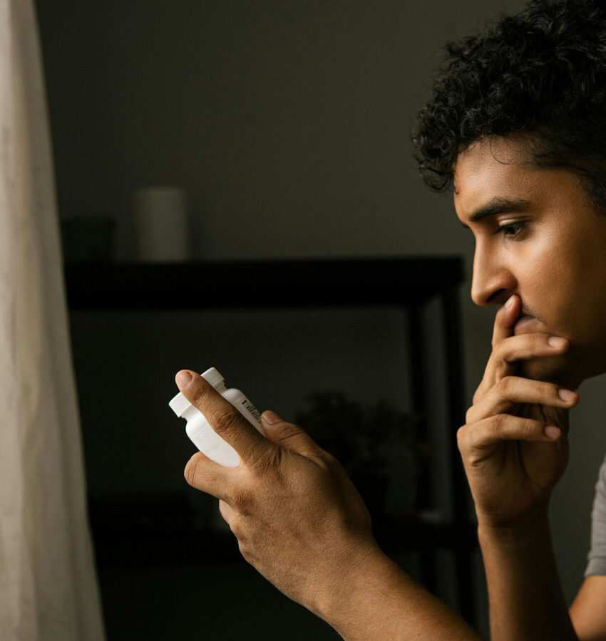 Man checking his opioid medication bottle